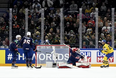 Goalkeeper Casey Desmith of the US, second right, in action against Oscar Lindberg of Sweden, right, during the 2023 IIHF Ice Hockey World Championships preliminary round group A match between Sweden and USA in Tampere, Finland, Tuesday, May 23, 2023. (Emmi Korhonen/Lehtikuva via AP)

- .