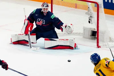 Sweden's Leo Carlsson, bottom right, scores the opening goal past United States goalie Casey DeSmith during the group A match between Sweden and United States at the ice hockey world championship in Tampere, Finland, Tuesday, May 23, 2023. (AP Photo/Pavel Golovkin)