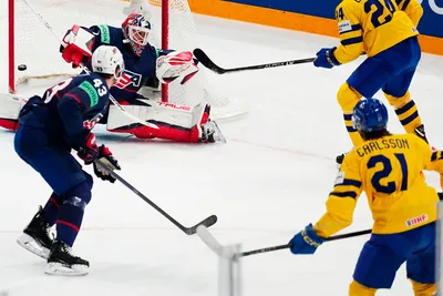 Sweden's Leo Carlsson, bottom right, scores the opening goal past United States goalie Casey DeSmith during the group A match between Sweden and United States at the ice hockey world championship in Tampere, Finland, Tuesday, May 23, 2023. (AP Photo/Pavel Golovkin)