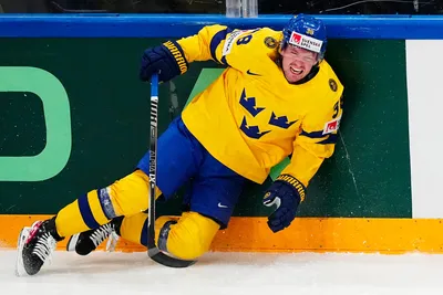 Sweden's Rasmus Sandin falls down in pain after a battle with United States Michael Eyssimont during the group A match between Sweden and United States at the ice hockey world championship in Tampere, Finland, Tuesday, May 23, 2023. (AP Photo/Pavel Golovkin)
