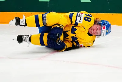 Sweden's Rasmus Sandin lays in pain after a battle with United States Michael Eyssimont during the group A match between Sweden and United States at the ice hockey world championship in Tampere, Finland, Tuesday, May 23, 2023. (AP Photo/Pavel Golovkin)