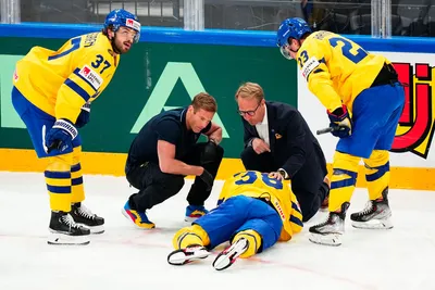 Sweden's Rasmus Sandin, bottom, lays in pain after a battle with United States Michael Eyssimont during the group A match between Sweden and United States at the ice hockey world championship in Tampere, Finland, Tuesday, May 23, 2023. (AP Photo/Pavel Golovkin)