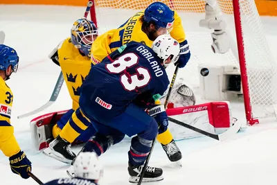 United States Conor Garland, centre, scores his side's second goal past Sweden's goalie Lars Johansson during the group A match between Sweden and United States at the ice hockey world championship in Tampere, Finland, Tuesday, May 23, 2023. (AP Photo/Pavel Golovkin)