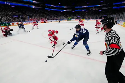 Denmark's Jesper Jensen Aabo, centre left, and Finland's Mikko Rantanen, centre right, battle for the puck during the group A match between Finland and Denmark at the ice hockey world championship in Tampere, Finland, Tuesday, May 23, 2023. (AP Photo/Pavel Golovkin)