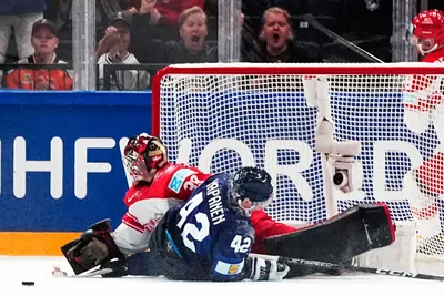 Finland's Kasperi Kapanen, centre, scores his side's sixth goal past Denmark's goalie George Sorensen during the group A match between Finland and Denmark at the ice hockey world championship in Tampere, Finland, Tuesday, May 23, 2023. (AP Photo/Pavel Golovkin)