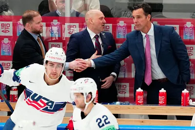 United States head coach David Quinn, right, celebrates with team members as they won the quarterfinal match between United States and Czech Republic at the ice hockey world championship in Tampere, Finland, Thursday, May 25, 2023. (AP Photo/Pavel Golovkin)