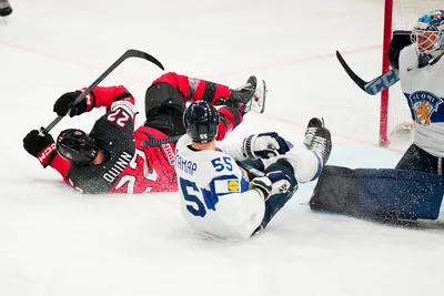 Canada's Jack Quinn, left, scores the opening goal past Finland's goalie Emil Larmi during the quarterfinal match between Canada and Finland at the ice hockey world championship in Tampere, Finland, Thursday, May 25, 2023. (AP Photo/Pavel Golovkin)
