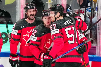Canada's Jack Quinn, centre, celebrates with teammates after scoring the opening goal during the quarterfinal match between Canada and Finland at the ice hockey world championship in Tampere, Finland, Thursday, May 25, 2023. (AP Photo/Pavel Golovkin)