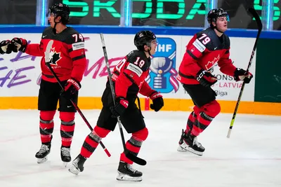 Canada's Samuel Blais, right, celebrates with teammates after scoring his side's second goal during the quarterfinal match between Canada and Finland at the ice hockey world championship in Tampere, Finland, Thursday, May 25, 2023. (AP Photo/Pavel Golovkin)