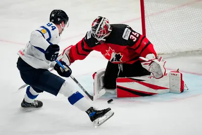 Finland's Kaapo Kakko, left, misses to score past Canada's goalie Samuel Montembeault during the quarterfinal match between Canada and Finland at the ice hockey world championship in Tampere, Finland, Thursday, May 25, 2023. (AP Photo/Pavel Golovkin)