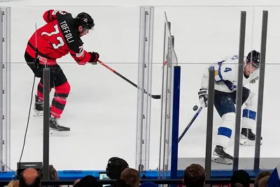 Canada's Tyler Toffoli, left, scores his side's fourth goal during the quarterfinal match between Canada and Finland at the ice hockey world championship in Tampere, Finland, Thursday, May 25, 2023. (AP Photo/Pavel Golovkin)