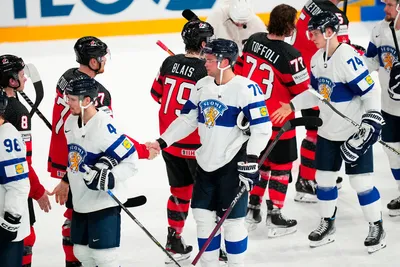 Finland's Teemu Hartikainen, centre, and Canada's Lawson Crouse shake hands after the quarterfinal match between Canada and Finland at the ice hockey world championship in Tampere, Finland, Thursday, May 25, 2023. (AP Photo/Pavel Golovkin)