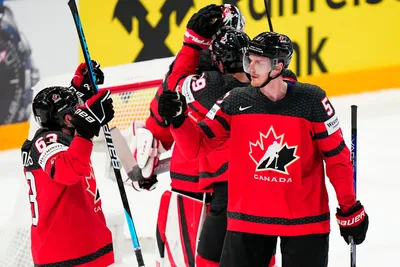 Canada's team players celebrate as they won the quarterfinal match between Canada and Finland at the ice hockey world championship in Tampere, Finland, Thursday, May 25, 2023. (AP Photo/Pavel Golovkin)