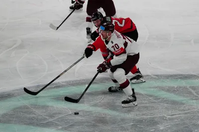 Latvia's Miks Indrasis (70) skates against Canada's Jack Quinn (22) during the semifinal match between Canada and Latvia at the ice hockey world championship in Tampere, Finland, Saturday, May 27, 2023. (AP Photo/Pavel Golovkin)