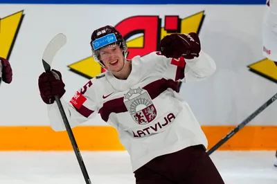 Latvia's Dans Locmelis (85) celebrates their goal during the semifinal match against Canada at the Ice Hockey World Championship in Tampere, Finland, Saturday, May 27, 2023. (AP Photo/Pavel Golovkin)