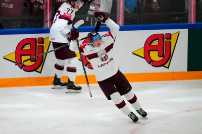 Latvia's Dans Locmelis (85) celebrates their goal during the semifinal match against Canada at the Ice Hockey World Championship in Tampere, Finland, Saturday, May 27, 2023. (AP Photo/Pavel Golovkin)