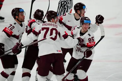 Latvia's Dans Locmelis (85) celebrates his goal with teammates during their semifinal match against Canada at the Ice Hockey World Championship in Tampere, Finland, Saturday, May 27, 2023. (AP Photo/Pavel Golovkin)