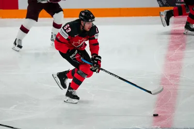 Canada's Jake Neighbours (63) skates down ice during their semifinal match against Latvia at the Ice Hockey World Championship in Tampere, Finland, Saturday, May 27, 2023. (AP Photo/Pavel Golovkin)