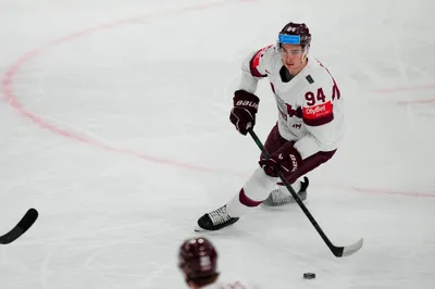 Latvia's Kristians Rubins (94) skates down ice during their semifinal match against Canada at the Ice Hockey World Championship in Tampere, Finland, Saturday, May 27, 2023. (AP Photo/Pavel Golovkin)