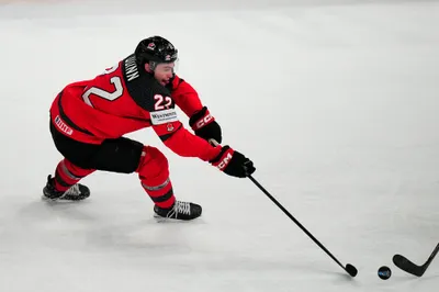 Canada's Jack Quinn (22) reaches for the puck during their semifinal match against Latvia at the Ice Hockey World Championship in Tampere, Finland, Saturday, May 27, 2023. (AP Photo/Pavel Golovkin)