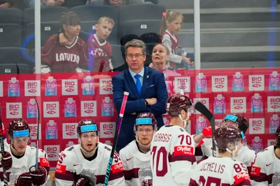 Latvia's head coach Harijs Vitolins watches from the bench during their semifinal match against Canada at the Ice Hockey World Championship in Tampere, Finland, Saturday, May 27, 2023. (AP Photo/Pavel Golovkin)