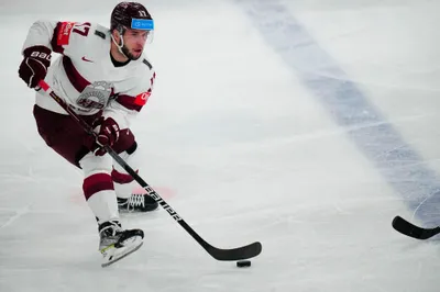 Latvia's Martins Dzierkals (17) passes the puck during their semifinal match against Canada at the Ice Hockey World Championship in Tampere, Finland, Saturday, May 27, 2023. (AP Photo/Pavel Golovkin)