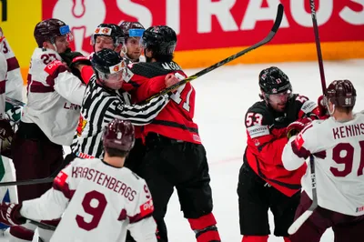 Referees break up a scuffle during the semifinal match between Canada and Latvia at the Ice Hockey World Championship in Tampere, Finland, Saturday, May 27, 2023. (AP Photo/Pavel Golovkin)