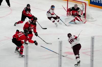 Latvia's Dans Locmelis shoots against Canada's goalie Samuel Montembeault during their semifinal match at the Ice Hockey World Championship in Tampere, Finland, Saturday, May 27, 2023. (AP Photo/Pavel Golovkin)