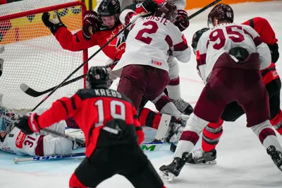 Latvia's goalie Arturs Silovs (31) falls to the ice in a battle at the net during their semifinal match against Canada at the Ice Hockey World Championship in Tampere, Finland, Saturday, May 27, 2023. (AP Photo/Pavel Golovkin)