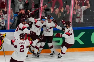 Latvia celebrates a goal by Latvia's Rudolfs Balcers, second right, during their semifinal match against Canada at the Ice Hockey World Championship in Tampere, Finland, Saturday, May 27, 2023. (AP Photo/Pavel Golovkin)