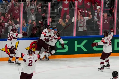 Latvia celebrates a goal by Latvia's Rudolfs Balcers during their semifinal match against Canada at the Ice Hockey World Championship in Tampere, Finland, Saturday, May 27, 2023. (AP Photo/Pavel Golovkin)