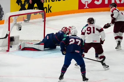 Latvia's Roberts Bukarts, right, scores a goal on United States goalie Casey DeSmith (1) in their bronze medal match at the Ice Hockey World Championship in Tampere, Finland, Sunday, May 28, 2023. (AP Photo/Pavel Golovkin)