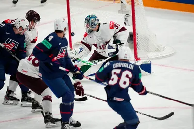 United States Rocco Grimaldi (56) scores a goal against Latvia's goalie Arturs Silovs (31) in their bronze medal match at the Ice Hockey World Championship in Tampere, Finland, Sunday, May 28, 2023. (AP Photo/Pavel Golovkin)