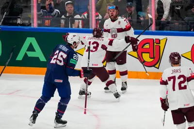 Latvia's Roberts Bukarts (71) celebrates with Rihards Bukarts (13) after scoring a goal in their bronze medal match against the United States at the Ice Hockey World Championship in Tampere, Finland, Sunday, May 28, 2023. (AP Photo/Pavel Golovkin)