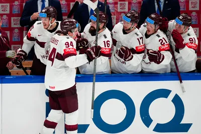 Latvia's Kristians Rubins (94) celebrates his goal with teammates in their bronze medal match against the United States at the Ice Hockey World Championship in Tampere, Finland, Sunday, May 28, 2023. (AP Photo/Pavel Golovkin)
