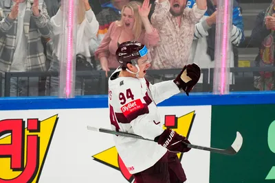 Latvia's Kristians Rubins (94) celebrates his goal in their bronze medal match against the United States at the Ice Hockey World Championship in Tampere, Finland, Sunday, May 28, 2023. (AP Photo/Pavel Golovkin)