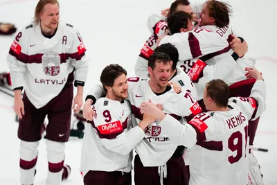 Latvia celebrates after defeating the United States in overtime of their bronze medal match at the Ice Hockey World Championship in Tampere, Finland, Sunday, May 28, 2023. (AP Photo/Pavel Golovkin)