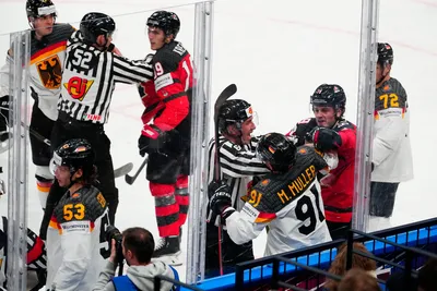 Referees breaks up a scuffle between Germany and Canada during the gold medal match at the Ice Hockey World Championship in Tampere, Finland, Sunday, May 28, 2023. (AP Photo/Pavel Golovkin)