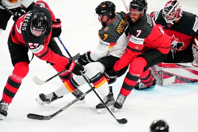 Canada's Pierre-Olivier Joseph (7) and Tyler Myers (57) defend against Germany's Maximilian Kastner (7) as goalie Samuel Montembeault covers the goal during the gold medal match at the Ice Hockey World Championship in Tampere, Finland, Sunday, May 28, 2023. (AP Photo/Pavel Golovkin)