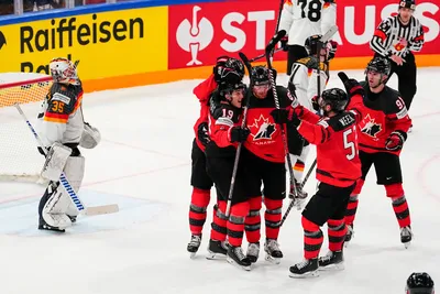 Canada celebrates after Lawson Crouse (67) scores on Germany's goalie Mathias Niederberger (35) during the gold medal match at the Ice Hockey World Championship in Tampere, Finland, Sunday, May 28, 2023. (AP Photo/Pavel Golovkin)