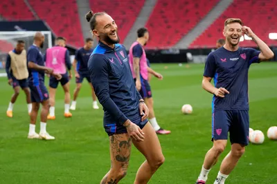 Sevilla's Nemanja Gudelj, left, and Sevilla's Ivan Rakitic smile during a training session at the Puskas Arena in Budapest, Hungary, Tuesday, May 30, 2023. The Europa League final match between Sevilla FC and AS Roma is held in Budapest on May 31, 2023. (AP Photo/Darko Bandic)

- XEUROPALEAGUEX