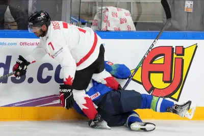 Pierre-Olivier Joseph of Canada fights for the puck during the group B match between Slovenia and Canada at the ice hockey world championship in Riga, Latvia, Sunday, May 14, 2023. (AP Photo/Roman Koksarov)