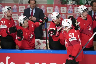 Dario Simion of Switzerland, foreground right, celebrates a goal with teammates during the group B match between Norway and Switzerland at the ice hockey world championship in Riga, Latvia, Sunday, May 14, 2023. (AP Photo/Roman Koksarov)