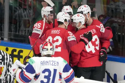 Switzerland team players celebrate during the group B match between Norway and Switzerland at the ice hockey world championship in Riga, Latvia, Sunday, May 14, 2023. (AP Photo/Roman Koksarov)