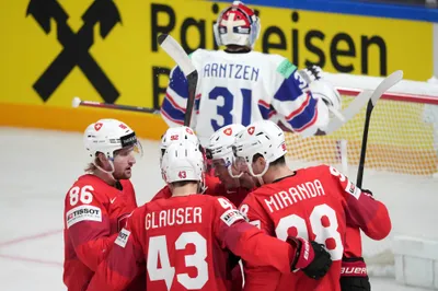Switzerland team players celebrate during the group B match between Norway and Switzerland at the ice hockey world championship in Riga, Latvia, Sunday, May 14, 2023. (AP Photo/Roman Koksarov)