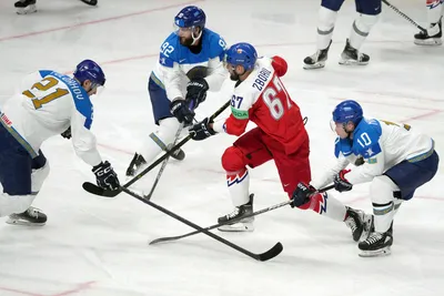 Jakub Zboril of Czech Republic, centre, fights for a puck with Kirill Polokhov, left, \k92, second left, and Nikita Mikhailis, right, of Kazakhstan during the group B match between Czech Republic and Kazakhstan at the ice hockey world championship in Riga, Latvia, Sunday, May 14, 2023. (AP Photo/Roman Koksarov)