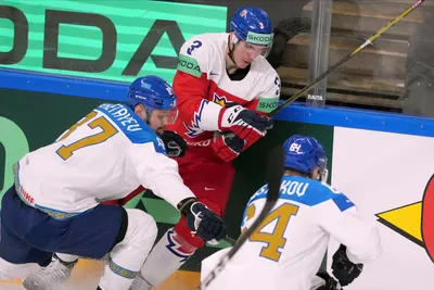 Ronald Knot of Czech Republic, centre, fights for a puck with Adil Beketayev, left, and Arkadi Shestakov of Kazakhstan during the group B match between Czech Republic and Kazakhstan at the ice hockey world championship in Riga, Latvia, Sunday, May 14, 2023. (AP Photo/Roman Koksarov)