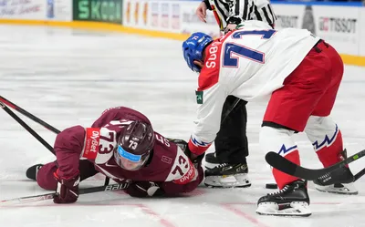 Deniss Smirnovs of Latvia, left, fights for a puck with Vladimir Sobotka of Czech Republic during the group B match between Latvia and Czech Republic at the ice hockey world championship in Riga, Latvia, Monday, May 15, 2023. (AP Photo/Roman Koksarov)