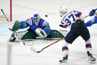 Goalie Gasper Kroselj of Slovenia, right, fights for a puck with Markus Vikingstad of Norway during the group B match between Slovenia and Norway at the ice hockey world championship in Riga, Latvia, Tuesday, May 16, 2023. (AP Photo/Roman Koksarov)