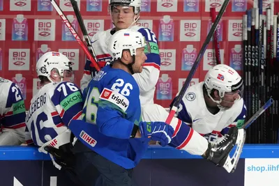Jan Urbas of Slovenia, front, fights for a puck with Emil Lilleberg of Norway during the group B match between Slovenia and Norway at the ice hockey world championship in Riga, Latvia, Tuesday, May 16, 2023. (AP Photo/Roman Koksarov)